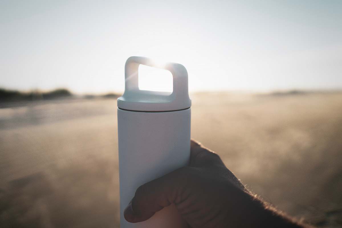 kiawah island person holding white tumbler beverage